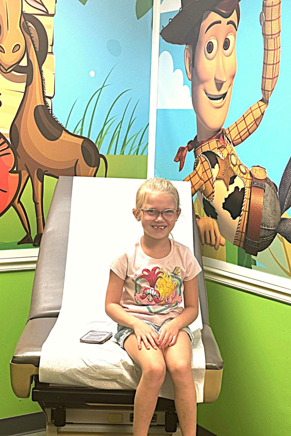 a little girl sitting on a chair