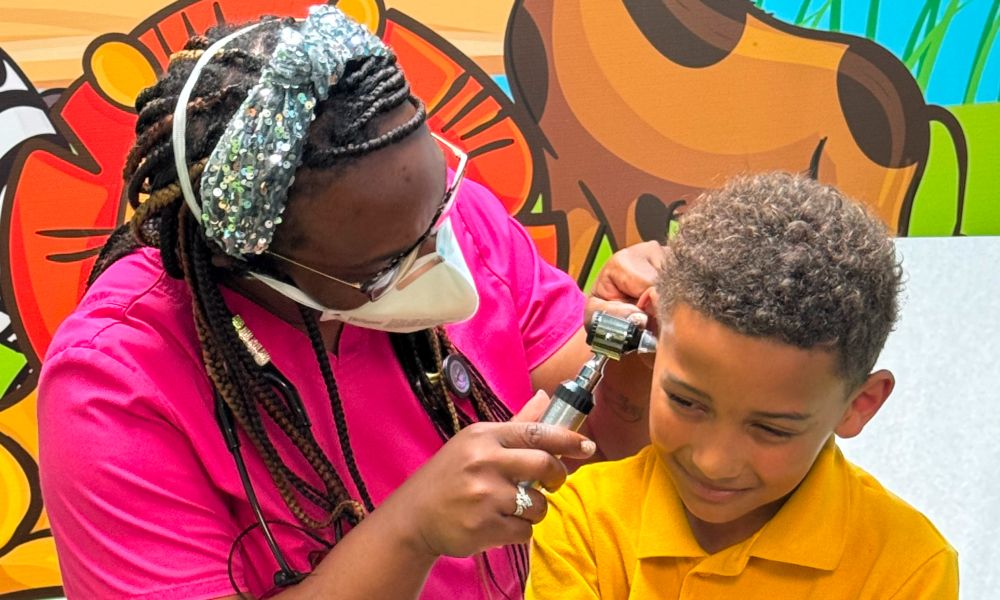 a doctor examining the kid's ear