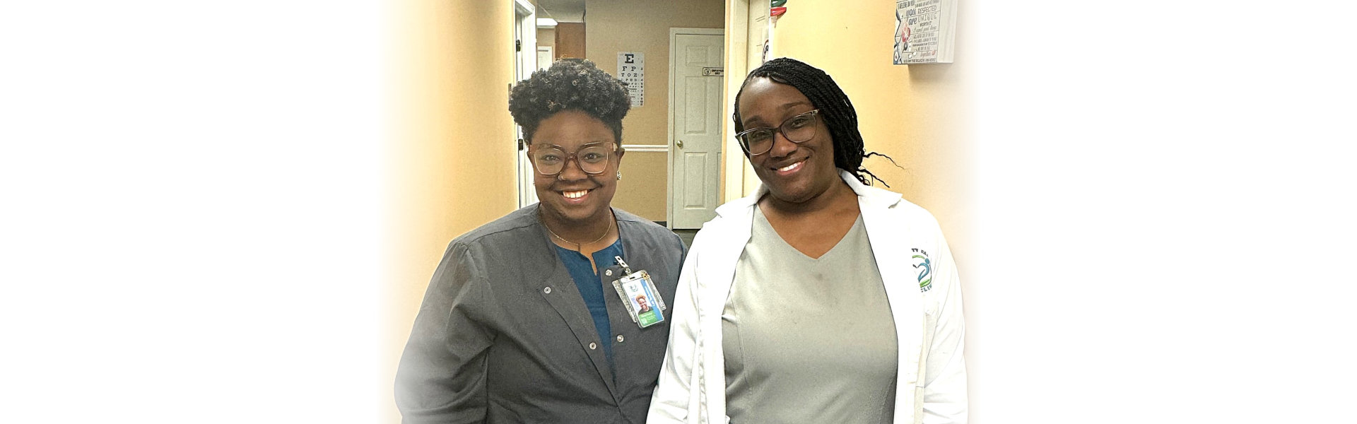 two women in scrubs smilling